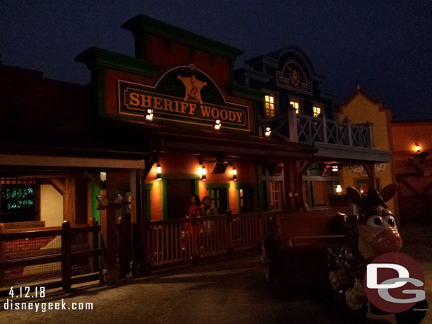 The backdrop is the queue and looks like a western town (beyond the town and queue is the walkway to Fantasyland to help with orientation of the land).