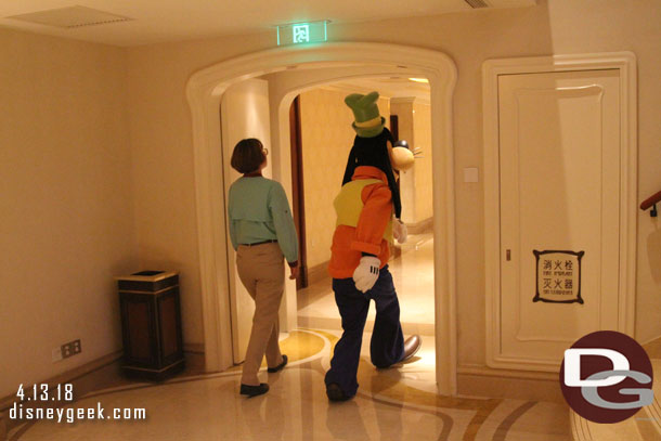 Goofy heading down a hallway.