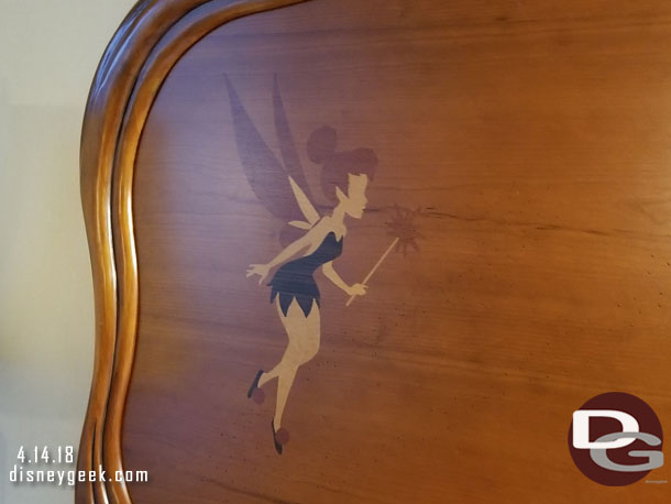 Tinker Bell in on corner of the headboard.