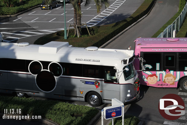 A Disney Resort Cruiser pulling out of the bus stops.