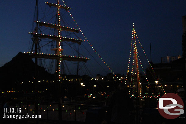 The boats in the harbor are decorated for Christmas.