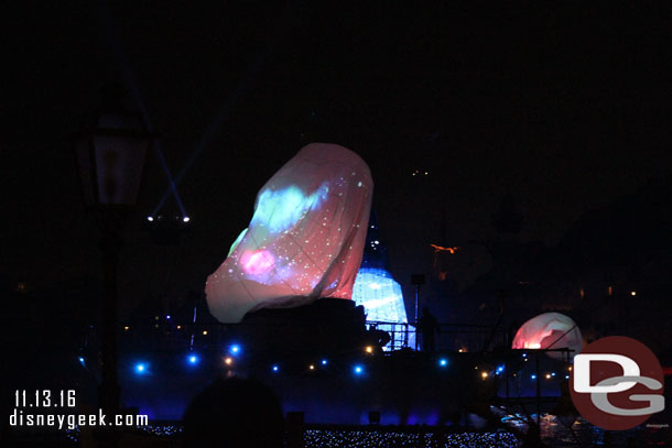 Large projection balloons inflate on the barges.