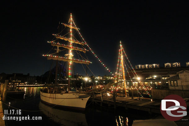 Most of the boats in the New York Harbor are decorated for Christmas.