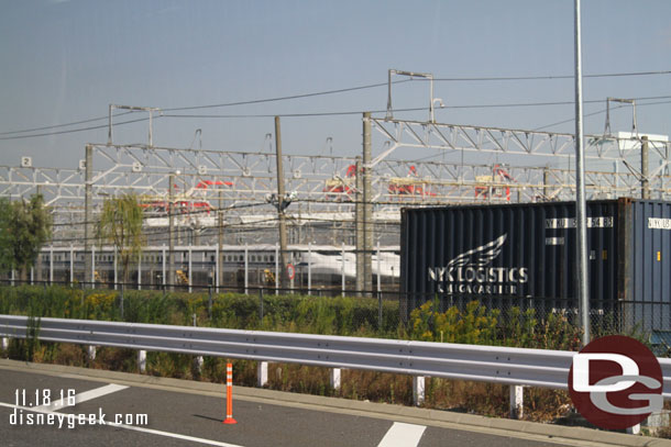 Bullet trains in a yard along the road.