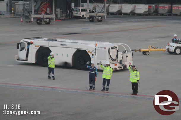 The ground crew pauses to wave to us (this was after bowing, I missed that).