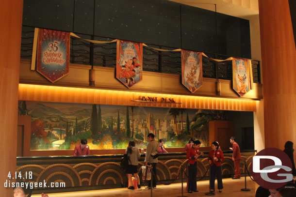 The front desk features banners for the 35th anniversary overhead.