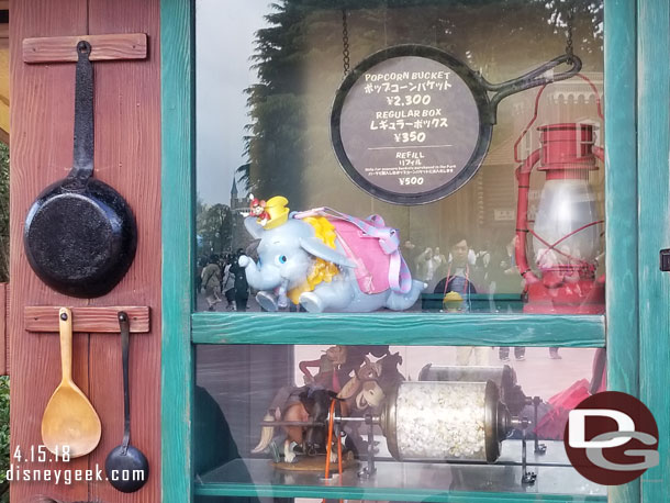 The Dumbo popcorn bucket is available in Westernland (and Fantasyland).  It is about $21.