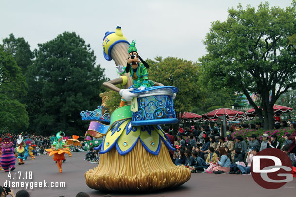 Goofy has his own float before the Alice in Wonderland group.