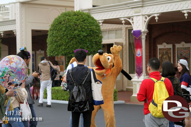 Pluto greeting guests at the entrance to World Bazaar.