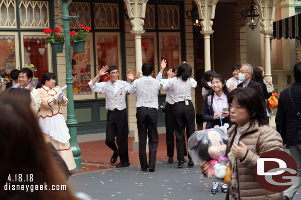 Cast Members in World Bazaar forming a tunnel to high five and cheer guests as they enter/exit the park.