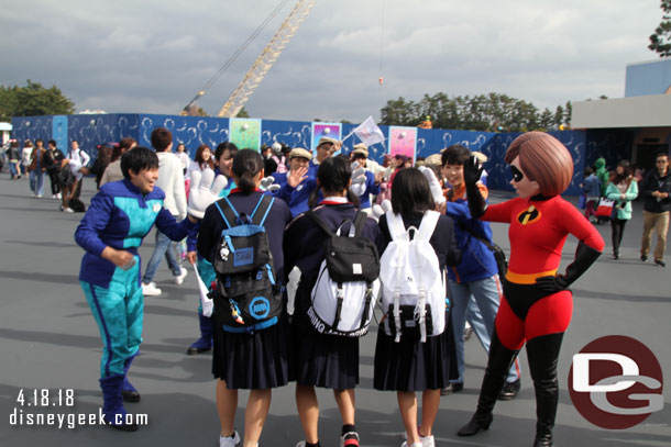 Cast Members forming another tunnel and Mrs. Incredible joining them.