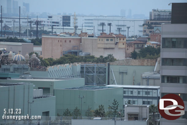 The large building in the center is Soarig at DisneySea.  The top portion is visible from in the park.