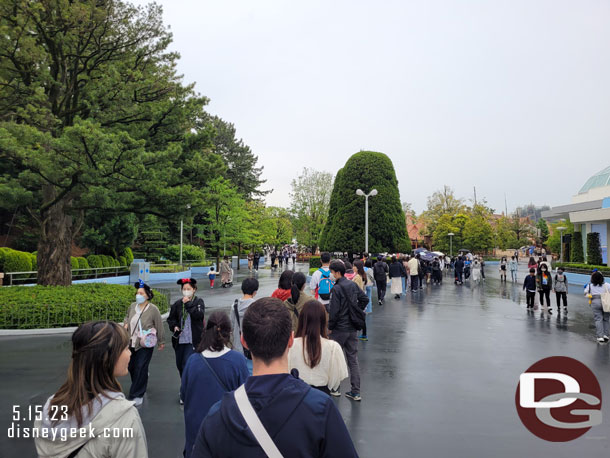 9:04am - The park officially opened 4 minutes ago.  I found the end of the queue for the Enchanted Tale of Beauty and the Beast.  I decided I was just going to get in line and wait it out if it was not raining.  So here we go.