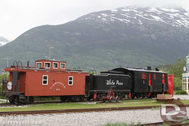 A train used for plowing parked outside.
