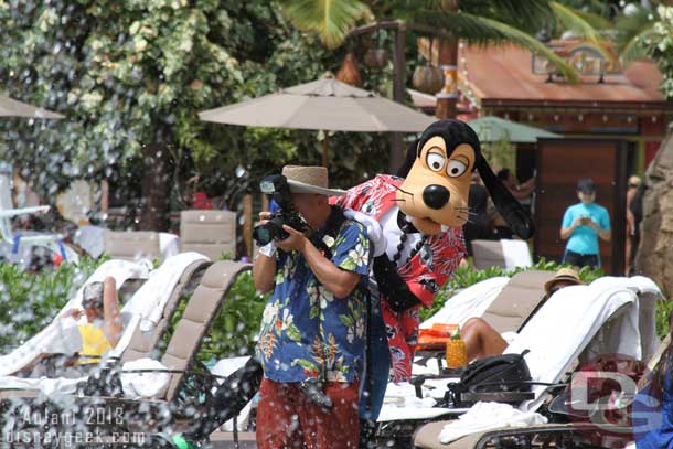 The splashing got a little out of control so Goofy took cover behind a PhotoPass photographer... 