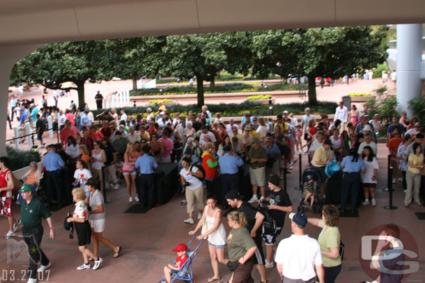 A good size line of people at EPCOTs security checkpoint near the monorail station