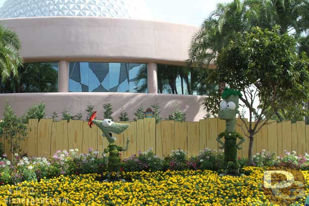 Phineas and Ferb in the planter behind Spaceship Earth.