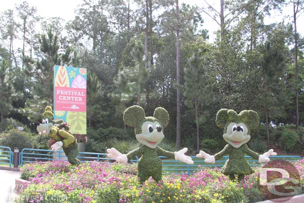 Mickey, Minnie, and Goofy in front of the Festival Center.