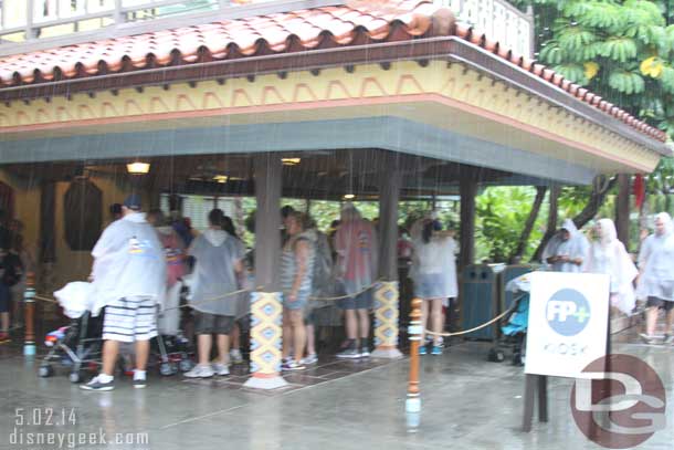 The Adventureland FastPass+ kiosk had a line out in the rain too.