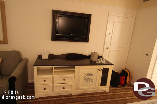 A TV and in the cabinet on the right a mini fridge.