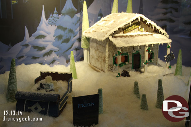 A gingerbread Wandering Oakens Trading Post in the window of the gift shop