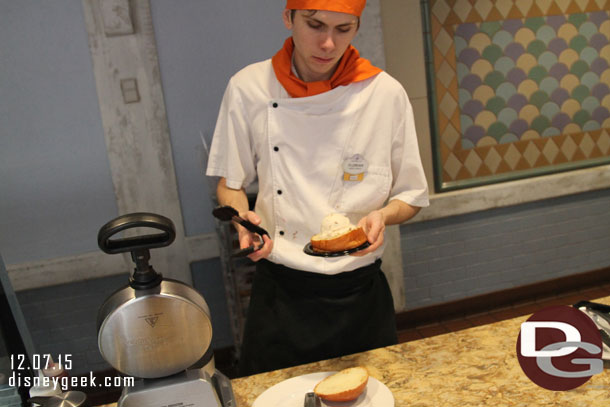 Creating a snack.. bread, ice cream, sauce, then heat.