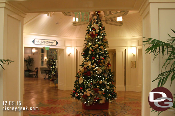 A Christmas tree in the center of the lobby area.