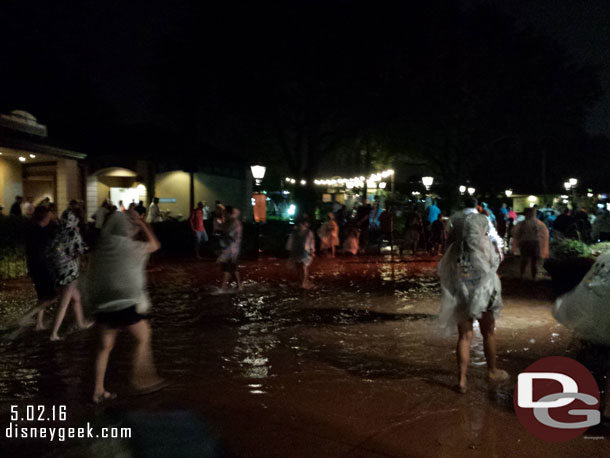 About 9:10 we set off in a light rain toward the bus, which of course was a good mile away.  The rain had slowed to a drizzle but there was a lot o flooding.  This area had water over ankle deep.  Guests were using the planters to try and avoid the mini lake. Guests in ECVs were stopped and trying to figure out how to exit the park.  There were no cast members in sight.