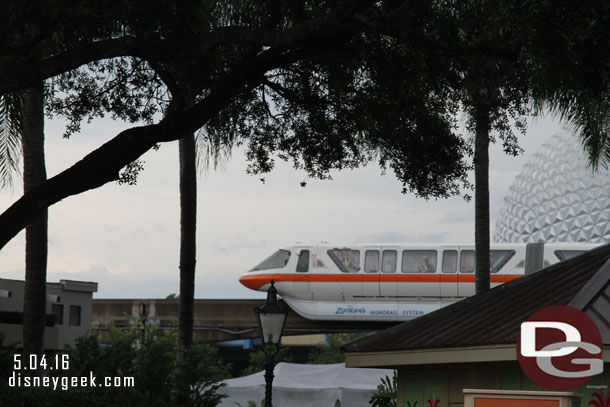 Monorail Orange with a Zootopia wrap passing by.