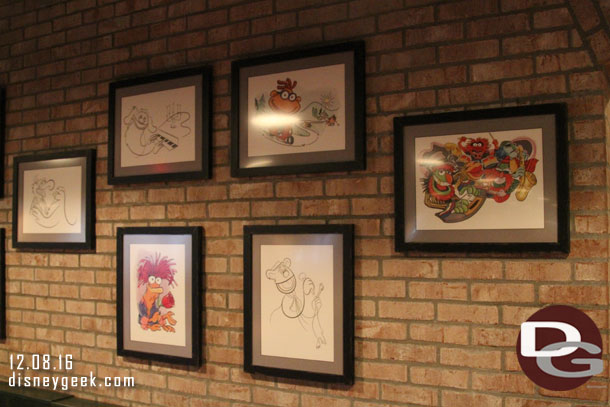 Caricatures on the wall by the restrooms.