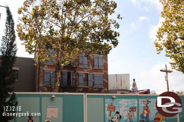 Some buildings standing still on the other side of the construction wall near the exit to Muppets