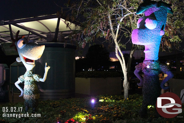 Phineas and Ferb topiaries at night.