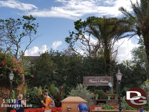 The Ratatouille show building from inside the park. It is visible between France and Morocco behind the garden area.