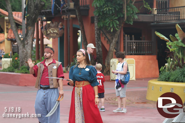 Some cast members near the small stage across from the attraction.