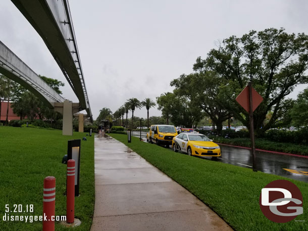 The Polynesian bus stop is not attached to the lobby nor is it covered.  So had to walk in the rain to get there.  Found it interesting Taxi's were stationed along the walkway (they were waiting to be called to the front entrance)