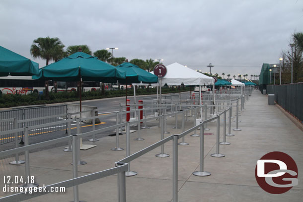 These are the temporary Disney Resort Bus stops. You have to walk through/by them to get to the park.  This is pleasant at 7:55am, but at park closing this is packed with guests.  These first two (furthest two) are for Pop Century and Art of Animation).