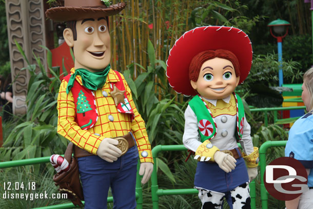Woody & Jessie greeting guests near Toy Story Mania. They feature some holiday pieces on their costumes.