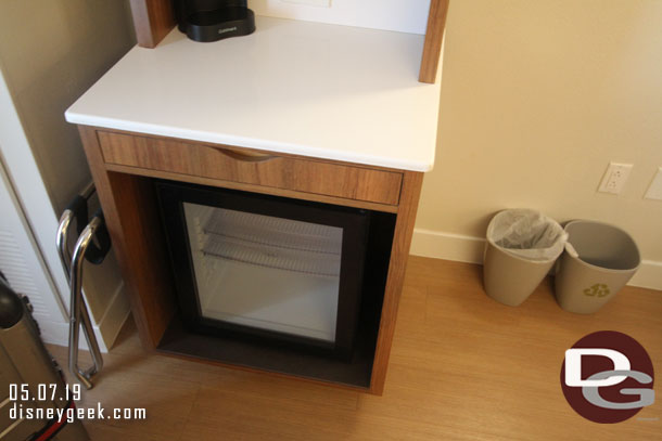 A refrigerator below the counter.