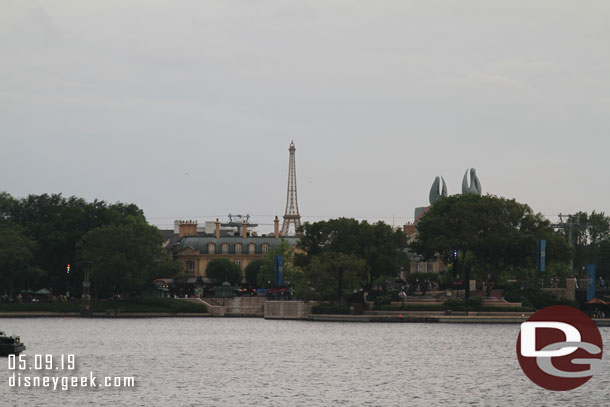 Looking across World Showcase lagoon.  you can see the top of one of the Skyliner towers over top of France.