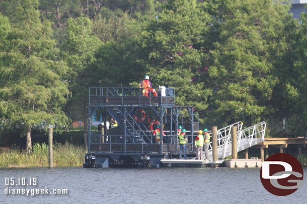 On the Art of Animation side of the lake a team was boarding and looking at the support boat for the Skyliner system.