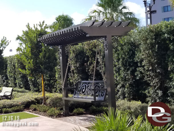 Swings and benches in the pool area.