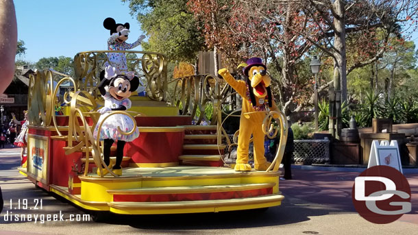 Minnie Mouse and Pluto are on the front of the float. Mickey Mouse is in the center.