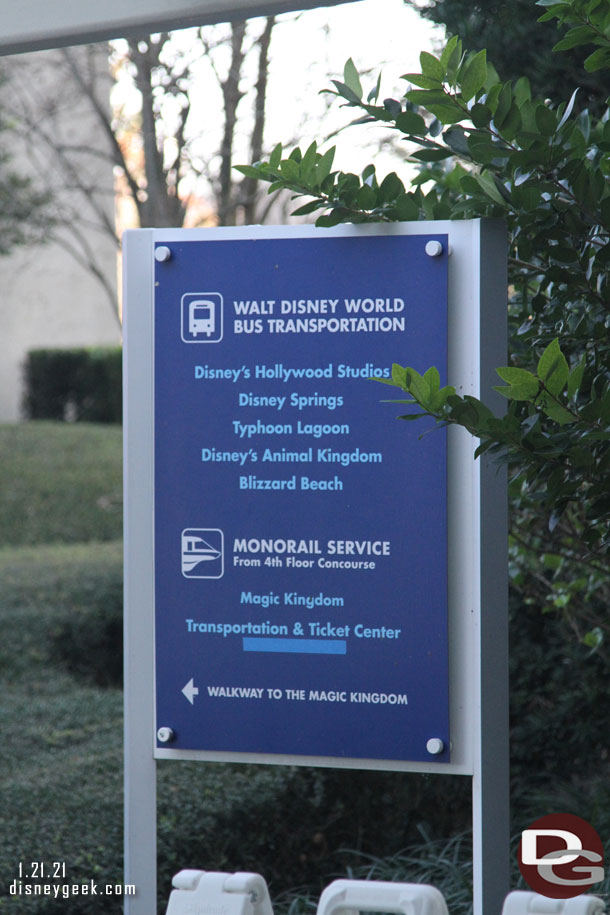 A sign at the bus stop listing transportation.  Thought it was noteworthy how Epcot Monorail is covered with tape.