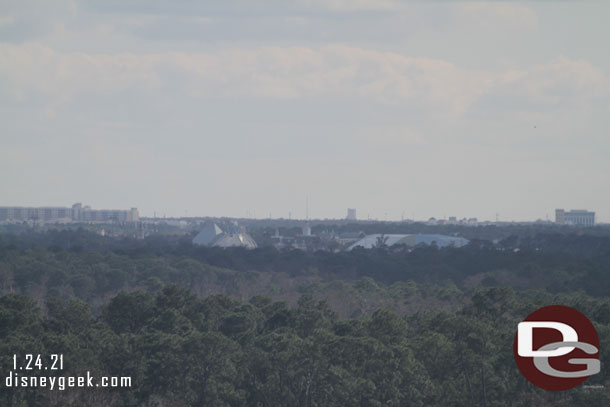 To the right more of Future World including Imagination, the Land and Soarin building visible over the tree line.