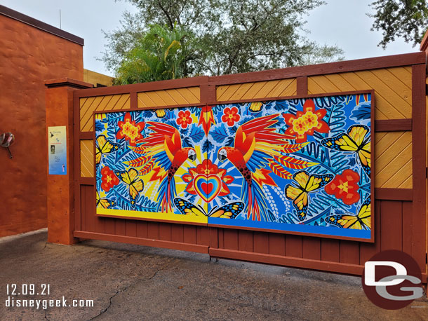 An Encanto photo wall on a backstage gate on Discovery Island.