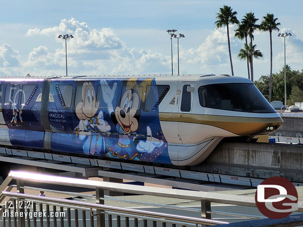 Monorail Gold with the 50th Anniversary Wrap pulling into the Transportation and Ticket Center on the Express Loop.