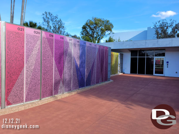 The tiles are now large walls that line the walkway on both sides of the entrance.