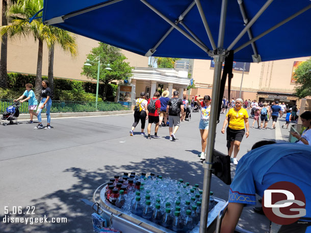 Castmember selling cold drinks near the line board. No cash allowed though, they lost a couple sales due to that as people walked by with cash.