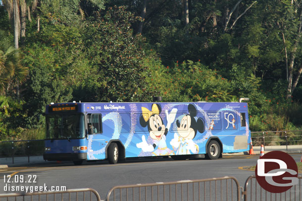 A 50th Anniversary wrapped bus parked nearby.