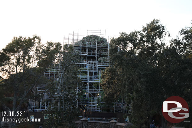 Tiana's Bayou Adventure construction.  The mountain is being covered with plant life and trees are being created in the foreground.